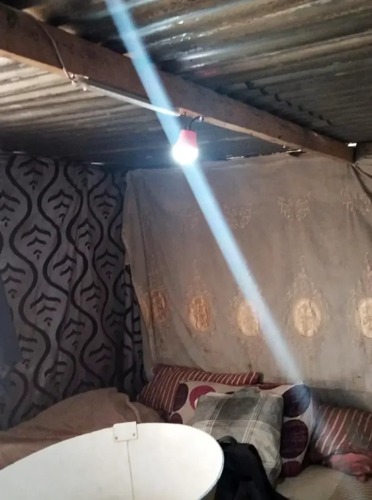 A home lit by a Sizanani solar light
