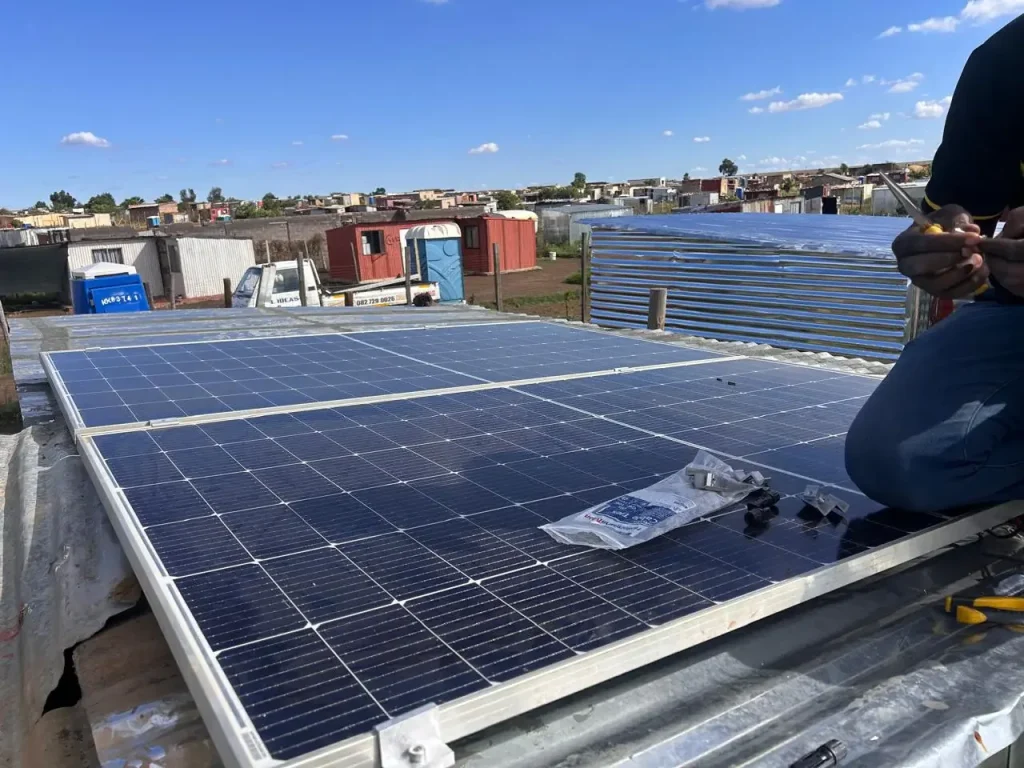 Solar panels being fitted on a roof