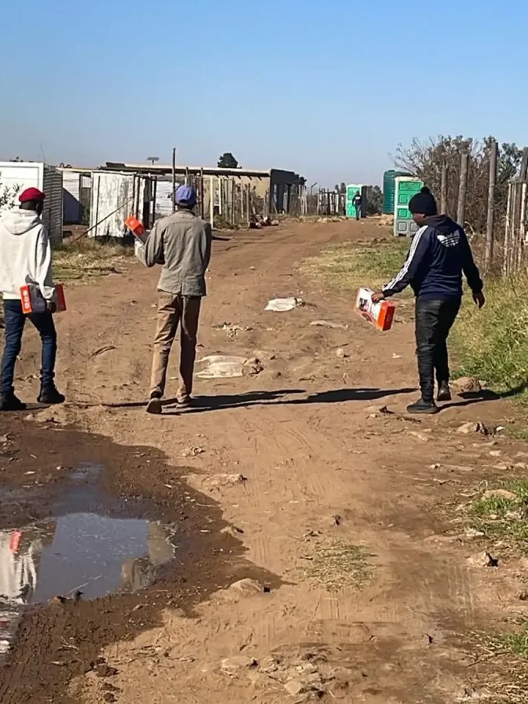 Sizanani team walking through an informal settlement